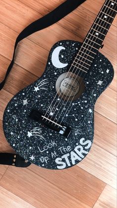 a black and white guitar with stars on it