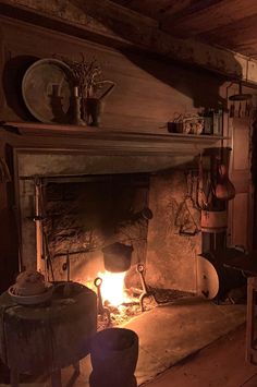 an old fireplace with pots and pans on it