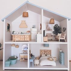 a doll house is shown with furniture and accessories on the shelves in front of it