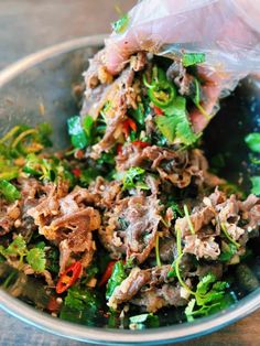 a close up of a plate of food with meat and veggies in it