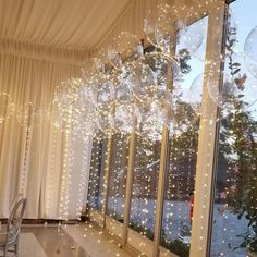 a room filled with lots of windows covered in lights