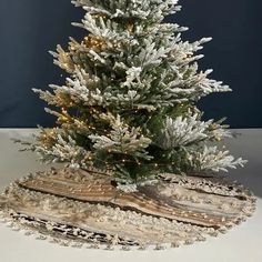 a white christmas tree with snow on it