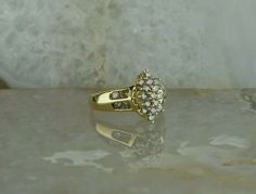 "10K Yellow Gold 1ct Diamond Cluster Ring, 8 side stones, 23 stones total snowflake shaped, central cluster, Champagne color SI clarity, shiny finish, .5\" across, Ring size 7, 4.6 grams Stock # BB221RTR67 Most rings are sizable for a small fee. If the ring you are considering is the incorrect size contact us for a quote. This listing contains photographs of the actual item you will receive. Our items are in excellent condition with little or no signs of wear and many are one of a kind pre-owned Gold Coin Ring, Snowflake Shape, Coin Ring, Champagne Diamond, Fine Jewelry Designers, Champagne Color, Diamond Cluster Ring, Size 10 Rings, Blue Topaz Ring