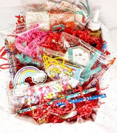 a basket filled with lots of different types of crafting supplies in plastic wrappers