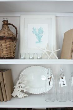 the shelves are filled with books and glassware