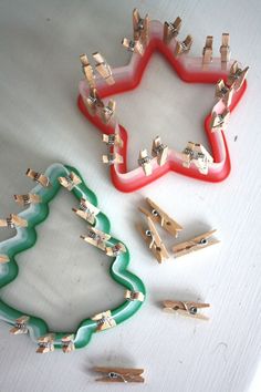 two christmas tree shaped cookie cutters sitting on top of a white table next to each other