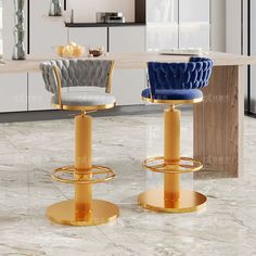 two gold stools in front of a marble countertop with blue velvet chairs and a white kitchen island