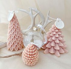 three pink and white christmas trees are next to each other