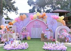 an outdoor birthday party with balloons and decorations