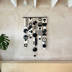 a clock hanging on the wall next to a potted plant