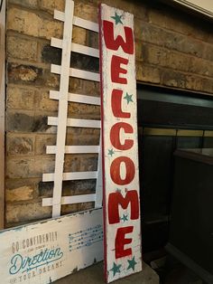 a wooden welcome sign sitting next to a fireplace