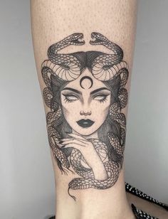 a woman's leg with a snake on it and her face in the middle