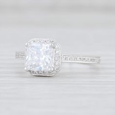 an engagement ring with a cushion cut diamond in the center