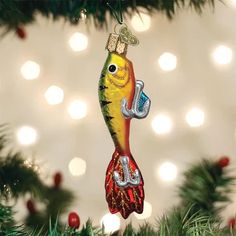 a fish ornament hanging from a christmas tree