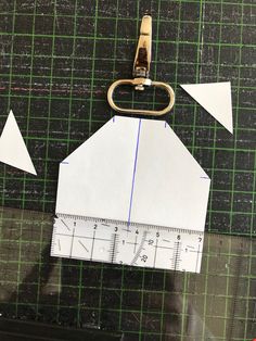 a piece of paper that has been cut into triangles and is being held by a pair of scissors