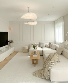 a living room filled with furniture and a large flat screen tv mounted on the wall