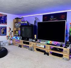 a living room filled with furniture and a flat screen tv on top of a wooden entertainment center