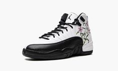 The Air Jordan 12 GS ‘Floral” is the youth sizing of the retro basketball shoe in a colorway with embroidered flower detailing on its design.  The Jordan 12 GS “Floral” updates Michael Jordan’s twelfth signature shoe with a unique floral design while also referencing the model’s original “Taxi” colorway.  The shoe features a white leather upper with a contrasting black synthetic mudguard on the toe and forefoot.  A floral motif is embroidered on either side of the shoe.  Black Jumpman and “Two 3 Unique Floral Design, Retro Basketball Shoes, Retro Basketball, Air Jordan 12, Jordan 12 Retro, Jordan 12, Jordans 12, Shoe Black, Stadium Goods