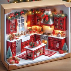 an open box with christmas decorations on the counter and in the middle is a model kitchen