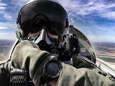 a man wearing a helmet and goggles while flying