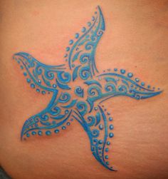 a blue bird tattoo on the back of a woman's stomach