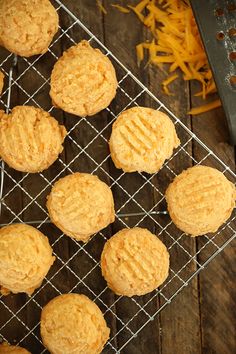 several cookies on a cooling rack with cheese next to them