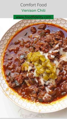 a white plate topped with chili and meat