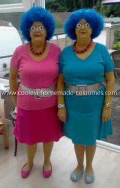 two women dressed in blue and pink standing next to each other