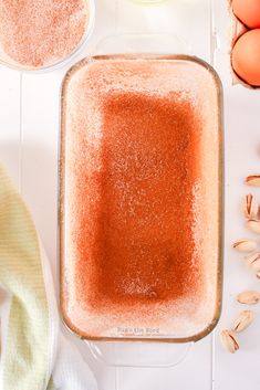 an uncooked baking dish filled with sugar and other ingredients on a white table