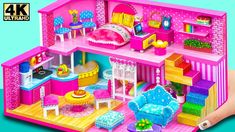 a pink doll house with furniture and accessories