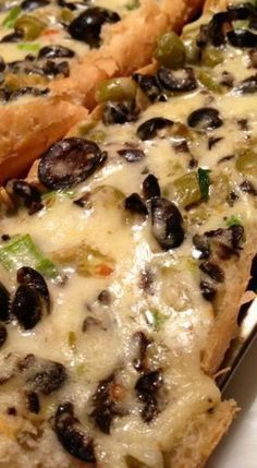 two slices of pizza with cheese and black olives