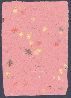 a pink square with yellow and red flowers on it's edges, against a black background