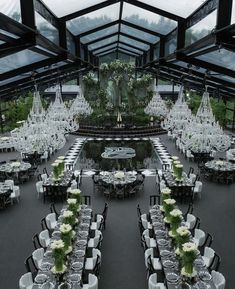 an indoor dining area with tables, chairs and chandeliers set up for a formal function