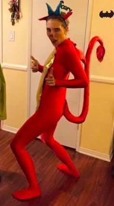 a man in a red costume is holding a banana