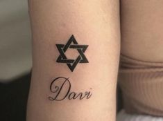 a woman's arm with the word dari tattooed on it