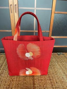 This is a tote bag made from summer obi fabric. Material: Both the front and back are made of silk obi Color: Vermilion Red Size: Height: Approx. 22 cm (8.7 inches) Width: Approx. 34 cm (13.4 inches) Depth: Approx. 11 cm (4.3 inches) Handle Length: Approx. 33 cm (13.0 inches) Features: Pocket inside the bag Removable bottom board with acrylic plate inside Handles reinforced with the same acrylic plate as the bottom board To prevent transparency, the silk used in the lining is also a matching col Vermilion Red, Handmade Tote Bag, Kimono Obi, Handmade Tote, Tote Bags Handmade, Fabric Material, Bag Making, Made In Japan, Inside Pocket