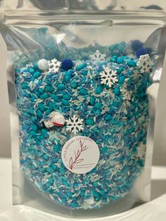 a bag filled with lots of blue and white sprinkles