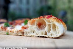 a close up of a piece of pizza on a table