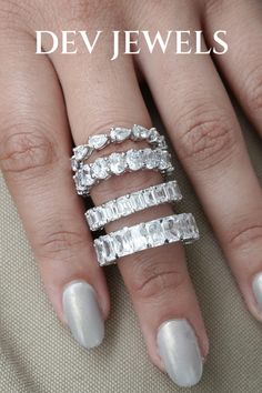 a woman's hand with three rings on it and the words dev jewels