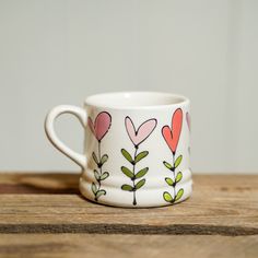 a coffee cup with hearts painted on it