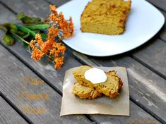 two slices of cake on plates with flowers and napkins next to them sitting on a wooden table