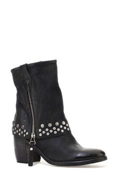 Double-down on contemporary Western styling in this leather boot designed with a dual zip closures and a fold-over-look shaft dotted with studs around the arch-grazing cuff. 3 1/2" heel; 1/2" platform 7 1/4" shaft Dual side-zip closures Leather upper and lining/synthetic sole Imported Punk Leather Moto Boots With Silver Studs, Edgy Leather Moto Boots With Grommets, Punk Leather Boots With Silver Studs, Edgy Winter Boots With Silver Studs, Rugged Moto Boots With Rivets For Fall, Leather Moto Boots With Grommets For Fall, Leather Punk Moto Boots With Zipper Closure, Edgy Leather Boots With Silver Studs, Winter Leather Boots With Silver Studs