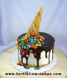 a cake decorated with chocolate, marshmallows and sprinkles