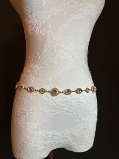 High quality metal chain & Jewel Stone belt.  Beautiful Pink and Silver Jewel on a gold metal base set off this belt.  Exclusively designed by FAN Design, this belt is made to a wide range of sizes. Matching necklace also available. Hand crafted to sizes.   Choose your waist size in inches, all belts will come with an extra 12 inch hanging chain Tap into the hottest new trend with chain belts! This chic piece of bodywear can be draped over your clothing to enhance your outfit or worn with bare midriff looks. Pair it with a simple black ensemble for an elegant finish. Perfect accessory for a wide range of outfits. Gold Chain Strap Jewelry For Wedding, Gold Rhinestone Chain Belt For Party, Gold Chain Belt With Rhinestones For Party, Elegant Gold Waist Chain For Wedding, Gold Belt Outfit, Gold Waist Chain, Jewelry Belt, Elegant Swimwear, Gold Chain Belt