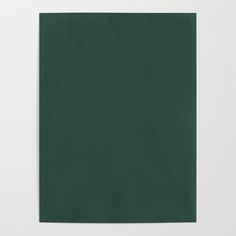 a green piece of paper on top of a white wall