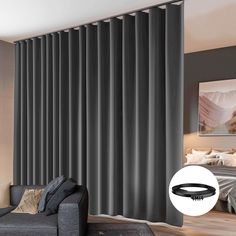 a living room with grey curtains and black furniture