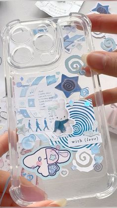 someone is holding an iphone case with stickers on it and the phone cover has been made out of clear plastic