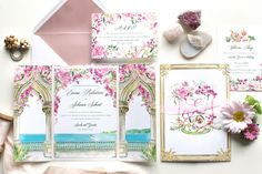 the wedding stationery is laid out with flowers