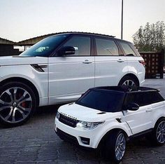 two white cars parked next to each other in a parking lot