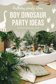 a birthday party table with dinosaur decorations and greenery on the table is featured in this postcard